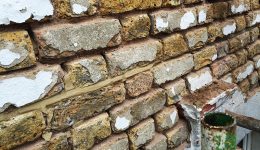 Render removed showing extent of damage to bricks