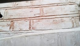 Restored brick faces replicating uneven surface of natural brick and mortar detailing.