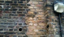 cracks and bowing in retaining wall