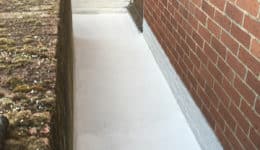 External walkway coated in Polyac Rapid prior to broadcasting with natural quartz